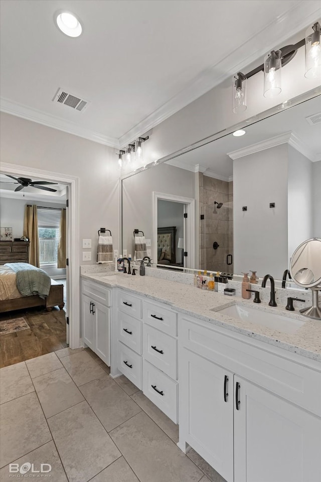 ensuite bathroom featuring connected bathroom, a sink, visible vents, ornamental molding, and a stall shower