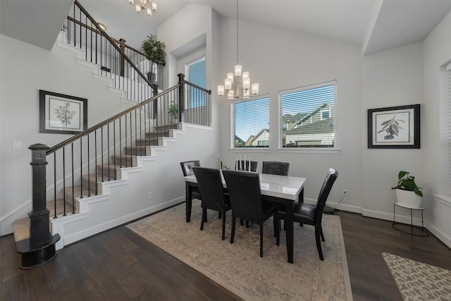 dining area featuring high vaulted ceiling, dark wood finished floors, and a notable chandelier