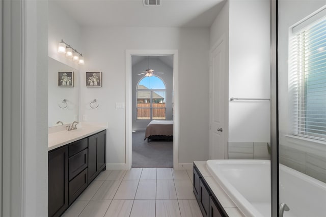 full bathroom featuring a healthy amount of sunlight, visible vents, connected bathroom, and a bath