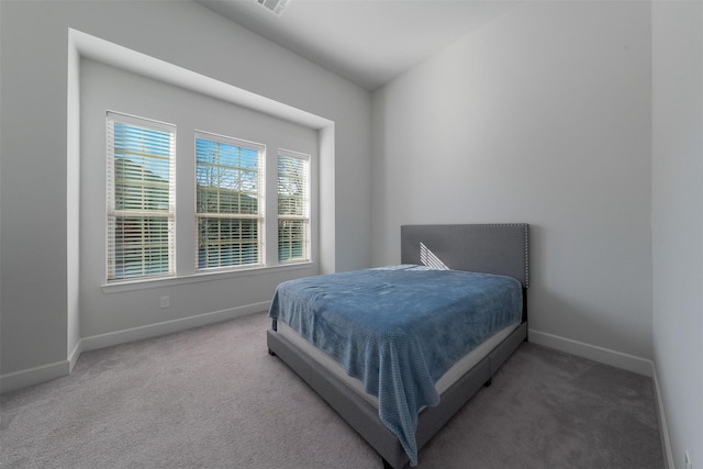 carpeted bedroom with visible vents and baseboards