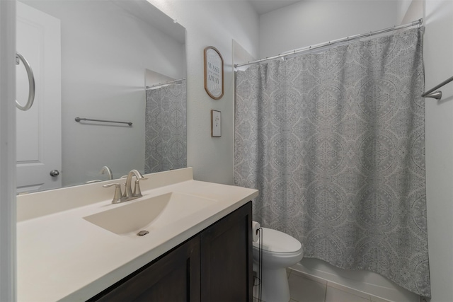 bathroom featuring toilet, vanity, and a shower with curtain