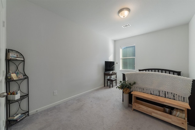 bedroom featuring visible vents, light carpet, and baseboards