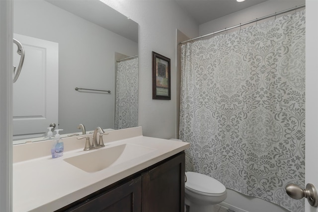 bathroom featuring toilet and vanity