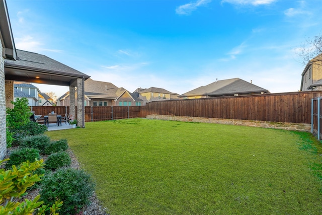 view of yard featuring a residential view, a fenced backyard, and a patio