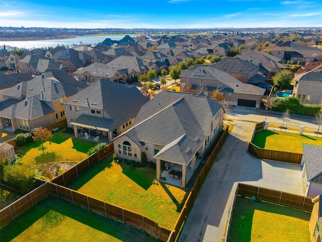 birds eye view of property featuring a water view and a residential view