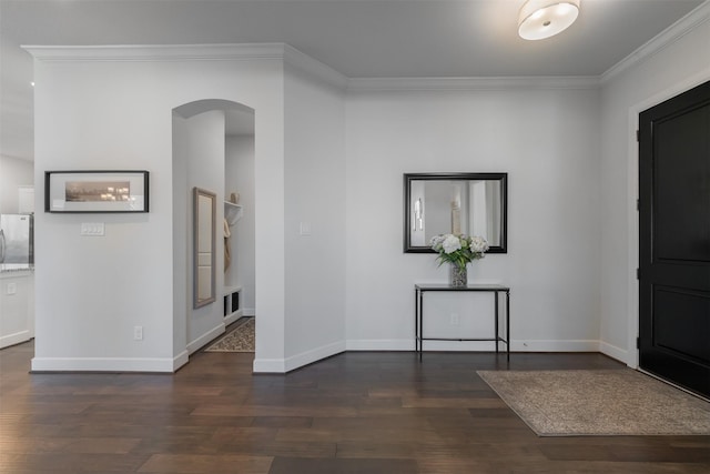 foyer entrance with arched walkways, visible vents, baseboards, ornamental molding, and dark wood-style floors