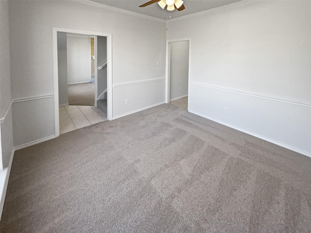 unfurnished room with ornamental molding, a ceiling fan, light tile patterned flooring, light carpet, and baseboards