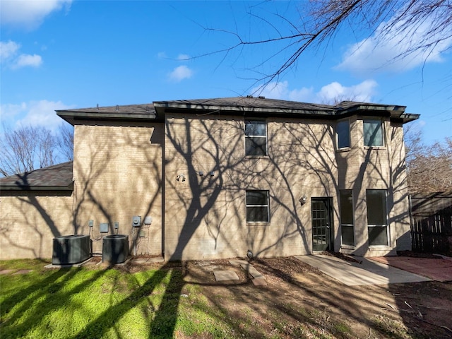 rear view of property with central AC