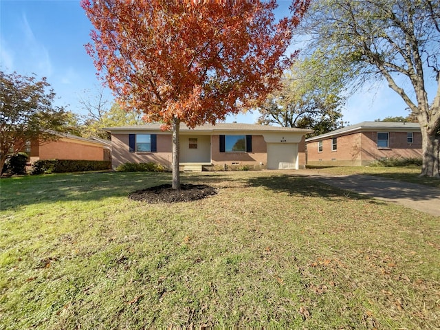 rear view of property featuring a lawn and driveway