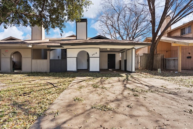 view of front of property with fence and stucco siding