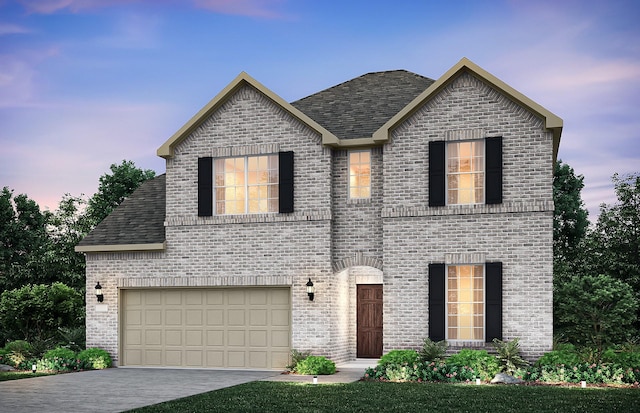 view of front of property featuring a garage, concrete driveway, brick siding, and a shingled roof