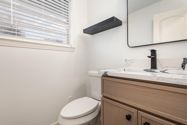 bathroom with toilet and vanity