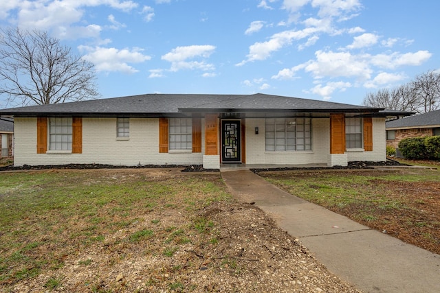 view of front of house with brick siding, a porch, and a front lawn