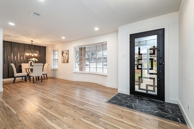 entrance foyer with visible vents, a chandelier, wood finished floors, and recessed lighting