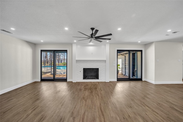 7004 Ledbetter Rd, Arlington, TX 76001 - unfurnished living room featuring wood finished floors, recessed lighting, baseboards, a brick fireplace, and a ceiling fan
