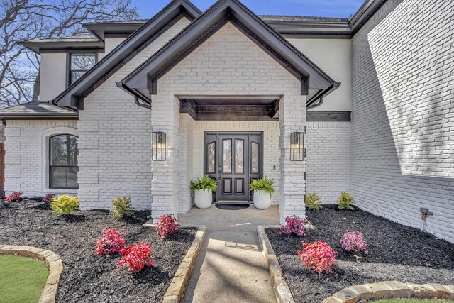 7004 Ledbetter Rd, Arlington, TX 76001 - view of exterior entry featuring brick siding and stucco siding