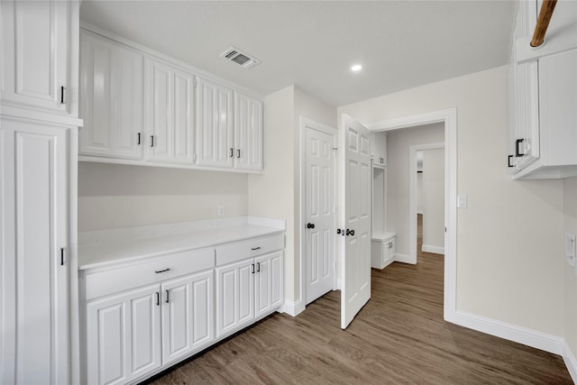 7004 Ledbetter Rd, Arlington, TX 76001 - kitchen featuring baseboards, white cabinets, wood finished floors, and recessed lighting