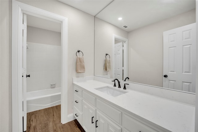 7004 Ledbetter Rd, Arlington, TX 76001 - full bathroom featuring wood finished floors, vanity, and washtub / shower combination