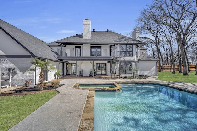7004 Ledbetter Rd, Arlington, TX 76001 - rear view of house featuring a balcony, a patio area, a chimney, a shingled roof, and a pool with connected hot tub