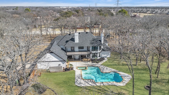 7004 Ledbetter Rd, Arlington, TX 76001 - back of house with a balcony, a pool with connected hot tub, a chimney, a patio, and a shingled roof