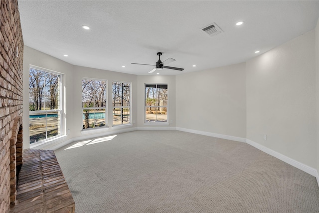 7004 Ledbetter Rd, Arlington, TX 76001 - unfurnished living room with carpet floors, recessed lighting, plenty of natural light, a ceiling fan, and baseboards