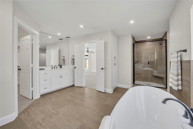 7004 Ledbetter Rd, Arlington, TX 76001 - bathroom with a stall shower, a soaking tub, vanity, recessed lighting, and baseboards