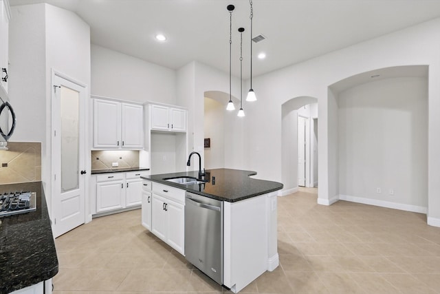869 Field Xing, Little Elm, TX 76227 - kitchen featuring appliances with stainless steel finishes, arched walkways, a sink, light tile patterned floors, and recessed lighting