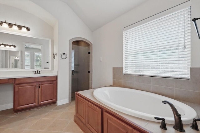 869 Field Xing, Little Elm, TX 76227 - bathroom featuring lofted ceiling, a garden tub, a stall shower, vanity, and tile patterned flooring