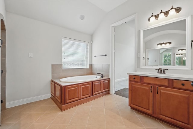 869 Field Xing, Little Elm, TX 76227 - bathroom with lofted ceiling, a garden tub, tile patterned floors, vanity, and baseboards