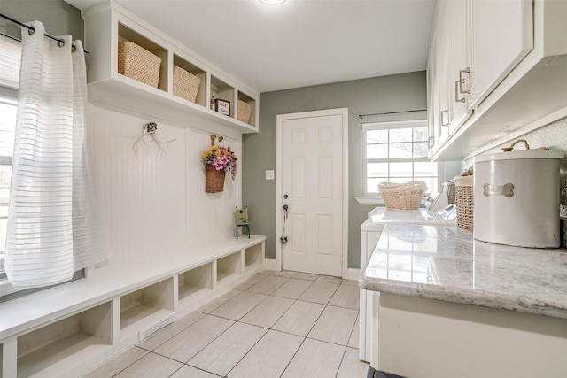 mudroom featuring light tile patterned floors and baseboards