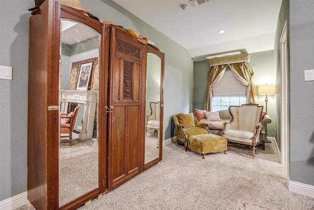 sitting room with light carpet, visible vents, a fireplace, and baseboards