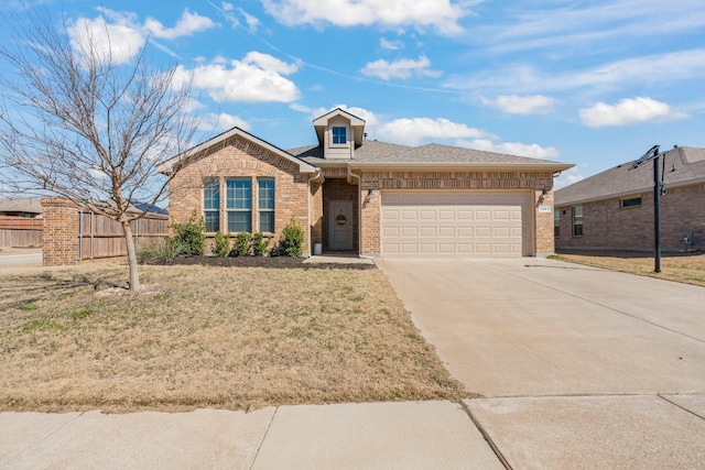 single story home with a garage, concrete driveway, roof with shingles, fence, and brick siding