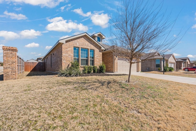 ranch-style home featuring a garage, brick siding, concrete driveway, fence, and a front yard