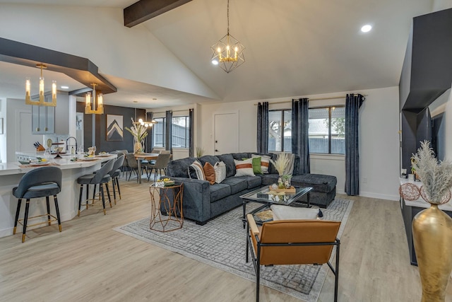 living room featuring light wood-style floors, a wealth of natural light, and a notable chandelier