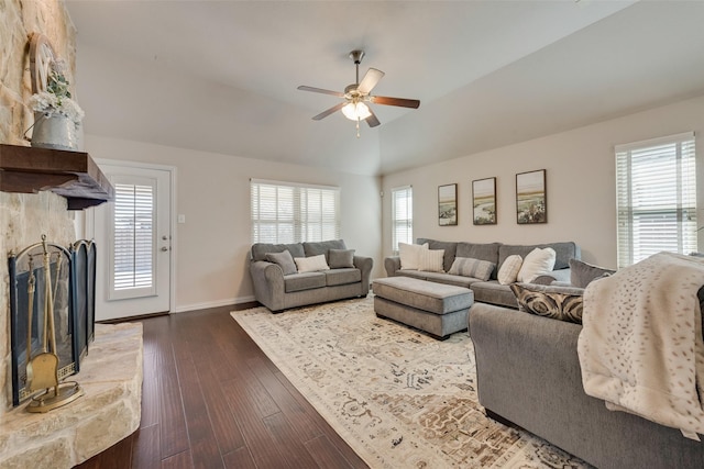 living room with baseboards, lofted ceiling, ceiling fan, wood finished floors, and a fireplace