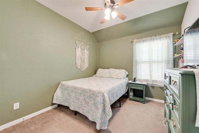 bedroom featuring a ceiling fan, light colored carpet, vaulted ceiling, and baseboards