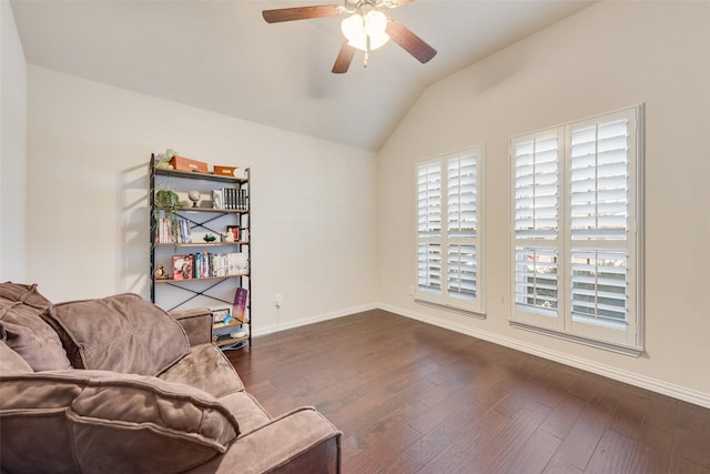 sitting room featuring baseboards, vaulted ceiling, and dark wood finished floors