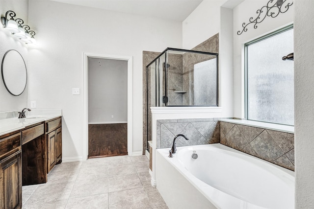 bathroom featuring tile patterned floors, a shower stall, vanity, and a bath