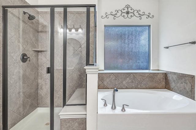 bathroom featuring a shower stall and a bath