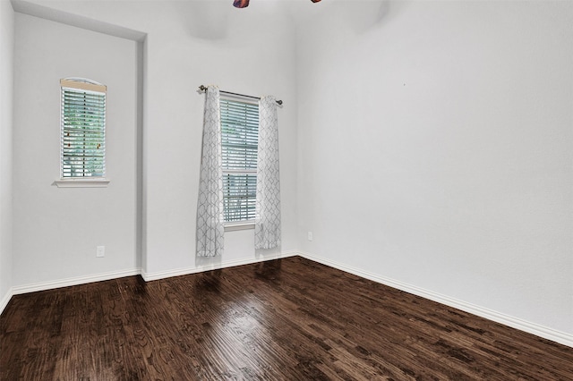 unfurnished room featuring baseboards, a ceiling fan, and wood finished floors