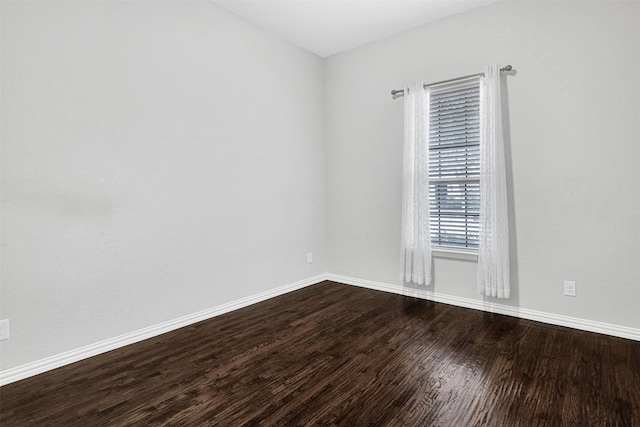 unfurnished room with wood finished floors and baseboards