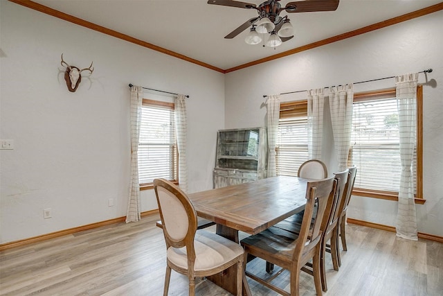 dining space with plenty of natural light, ornamental molding, and light wood-type flooring