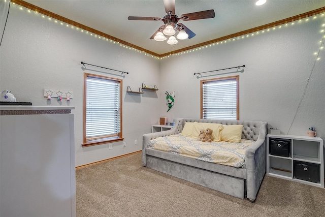 carpeted bedroom featuring ceiling fan, a textured wall, baseboards, and crown molding