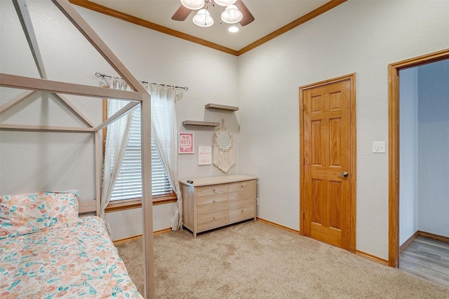 bedroom featuring baseboards, a ceiling fan, light colored carpet, and crown molding