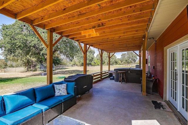 view of patio featuring a hot tub, an outdoor living space, and french doors