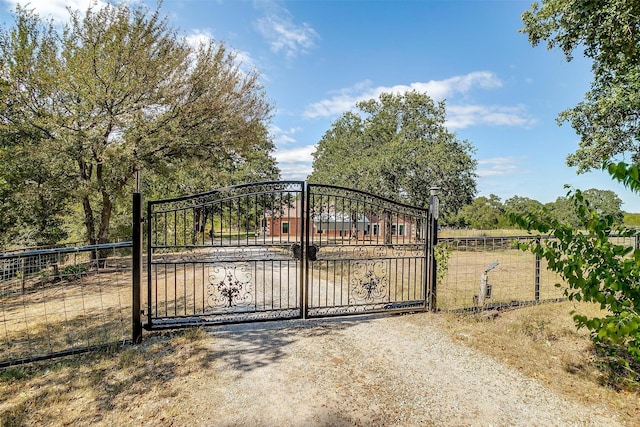 view of gate with fence