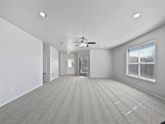 unfurnished room featuring light carpet, recessed lighting, and baseboards