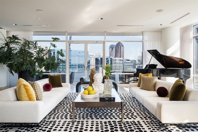 living room with floor to ceiling windows, visible vents, and a city view