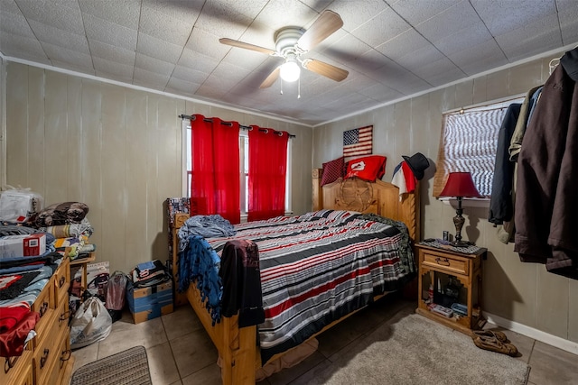 tiled bedroom featuring ceiling fan