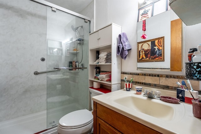 bathroom with a stall shower, vanity, toilet, and decorative backsplash